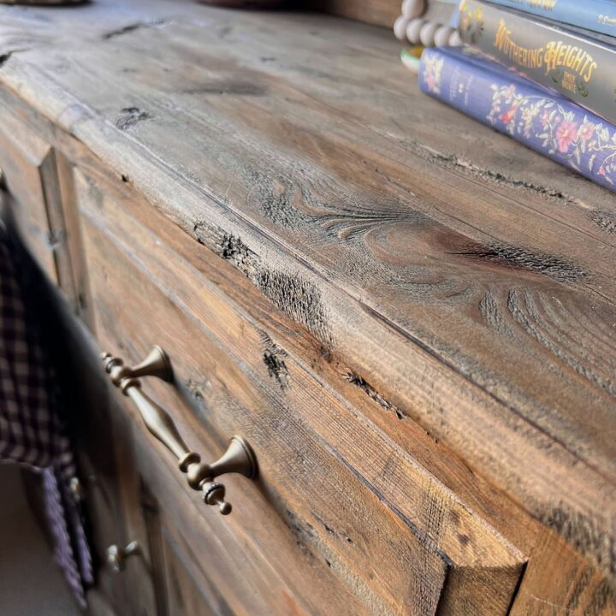 A close up of the texture and distressed details of a medium oak Welsh dresser