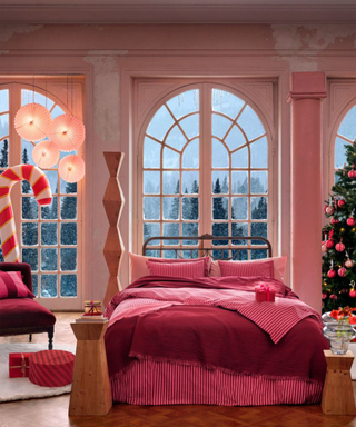 A festive bedroom with a candy cane striped bedding set in pink and red