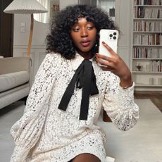Influencer wears a white lace dress.