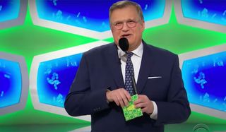 Drew Carey about to open an envelope on The Price Is Right