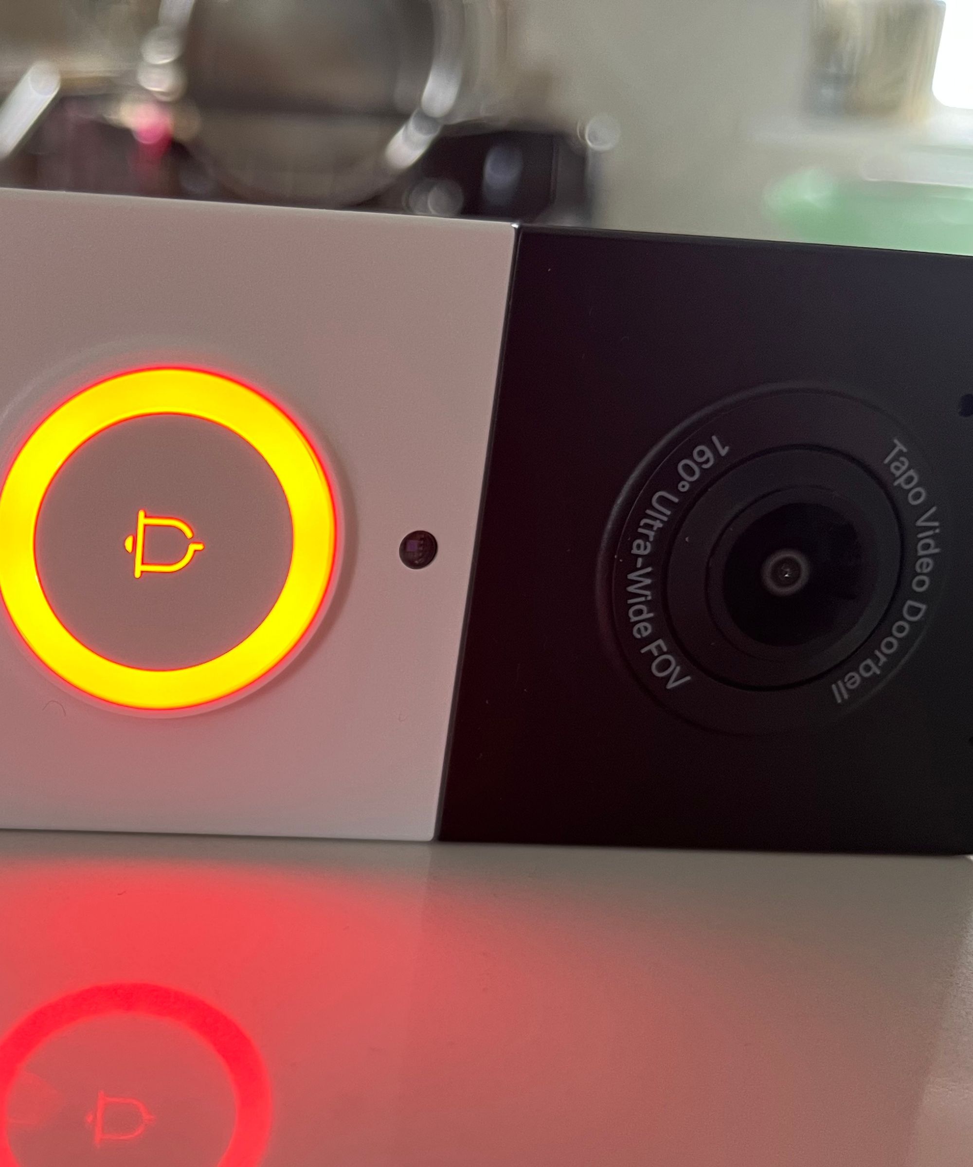 Orange light showing charging on the Tapo D210 Video Doorbell.