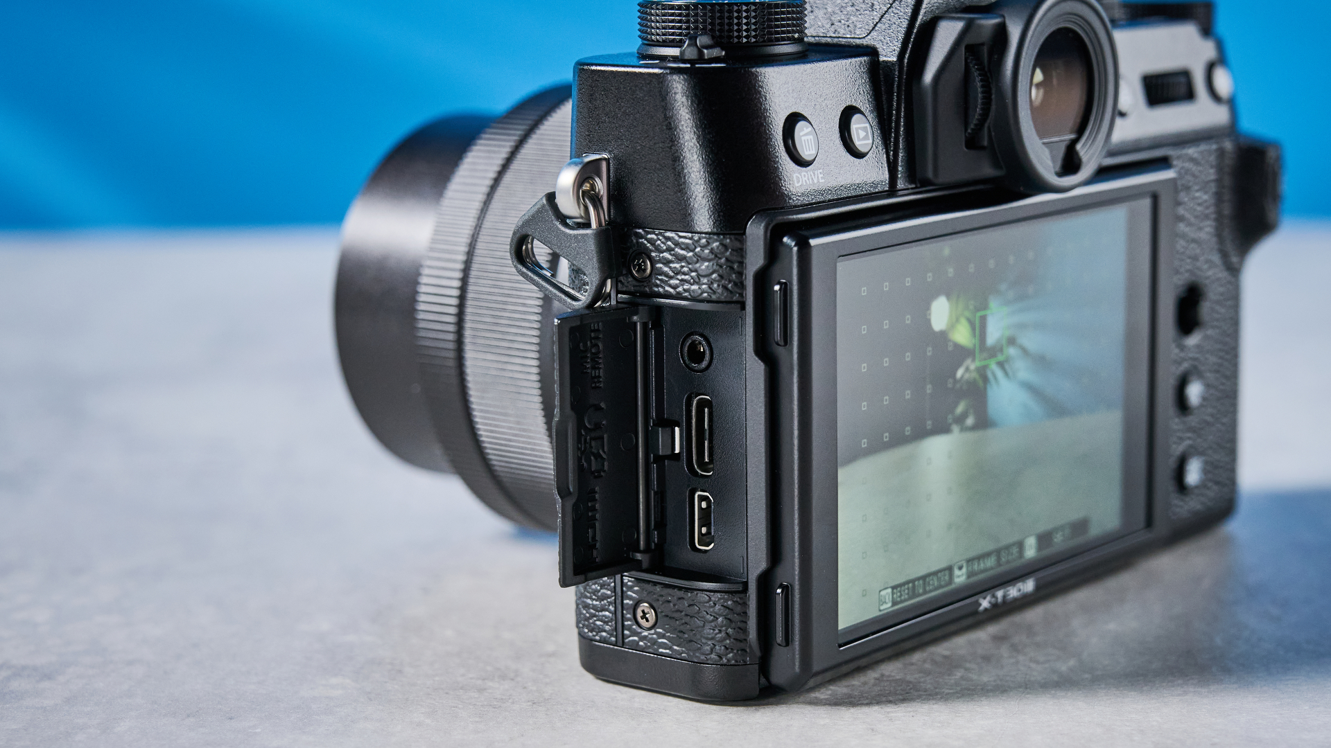 The Fujifilm X-T30 III with its side hatch open showing its connection ports