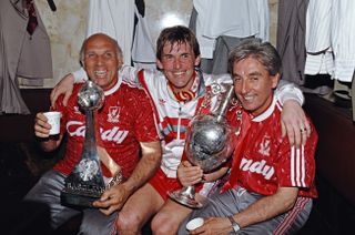 Kenny Dalglish celebrates the Division One title with Liverpool colleagues Ronnie Moran and Roy Evans on his final appearances as a player for the Reds in 1990.