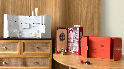 The best advent calendars from The White Company, Anthropologie and Nespresso displayed on a table and chest of drawers