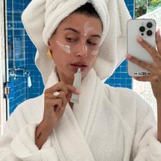 Hailey Bieber applying lip balm for dry lips