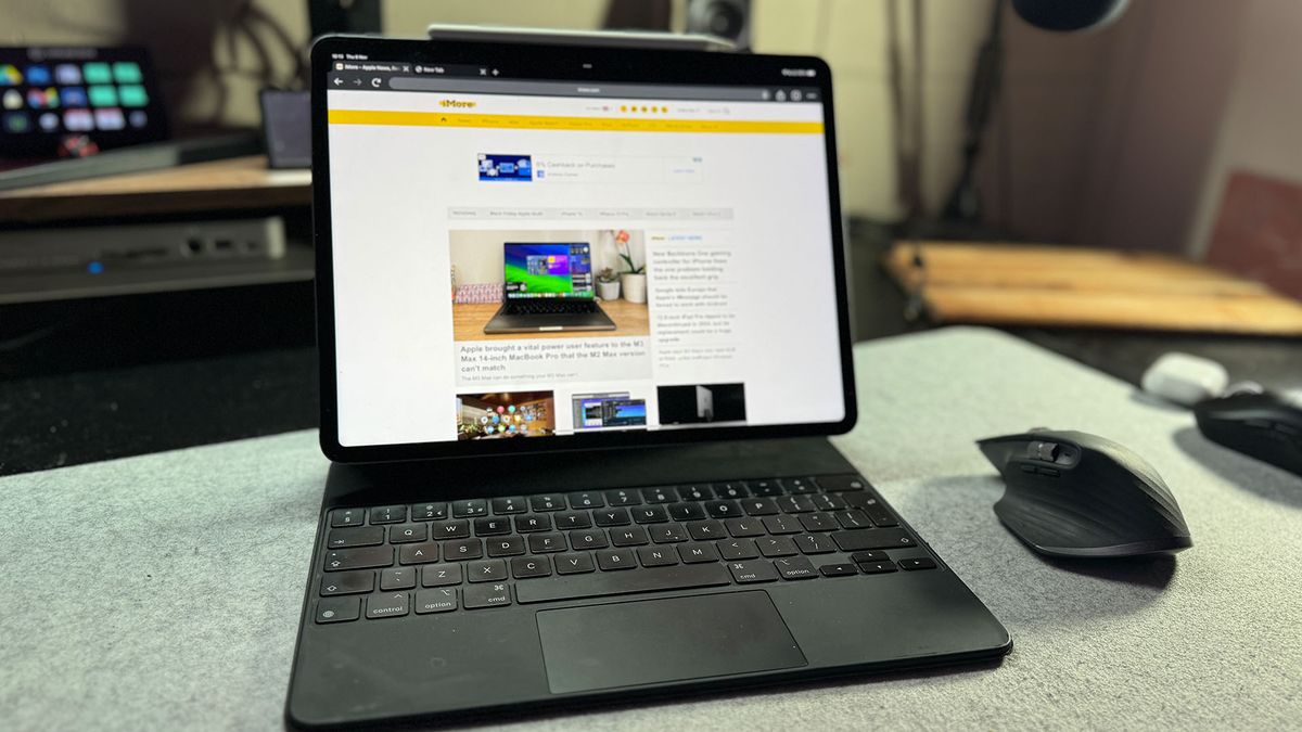 iPad Pro 12.9-inch on a desk with a wireless mouse and Apple Magic Keyboard attached