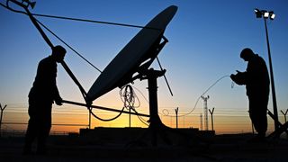 Crew members manually redirect an antenna for Space Force's Bounty Hunter counterspace system at Al Udeid Air Base, Qatar, Jan. 30, 2017.