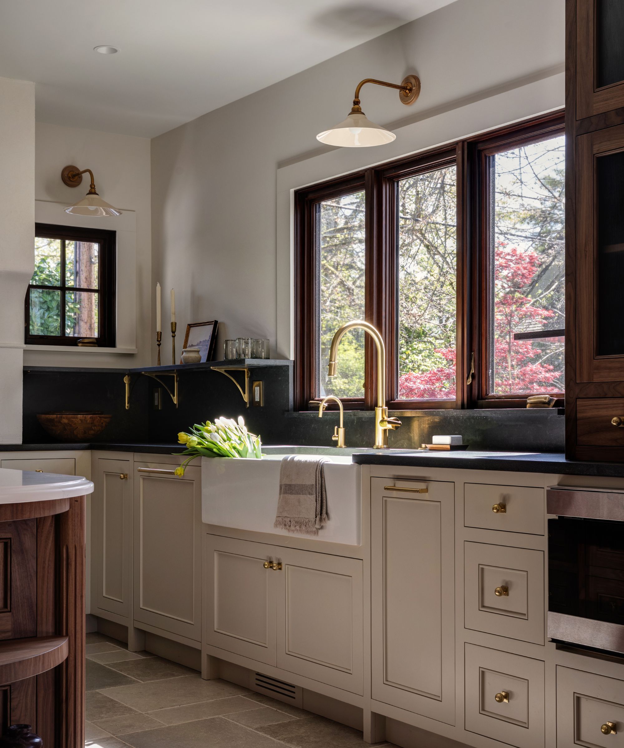 A white and wood kitchen with black countertops