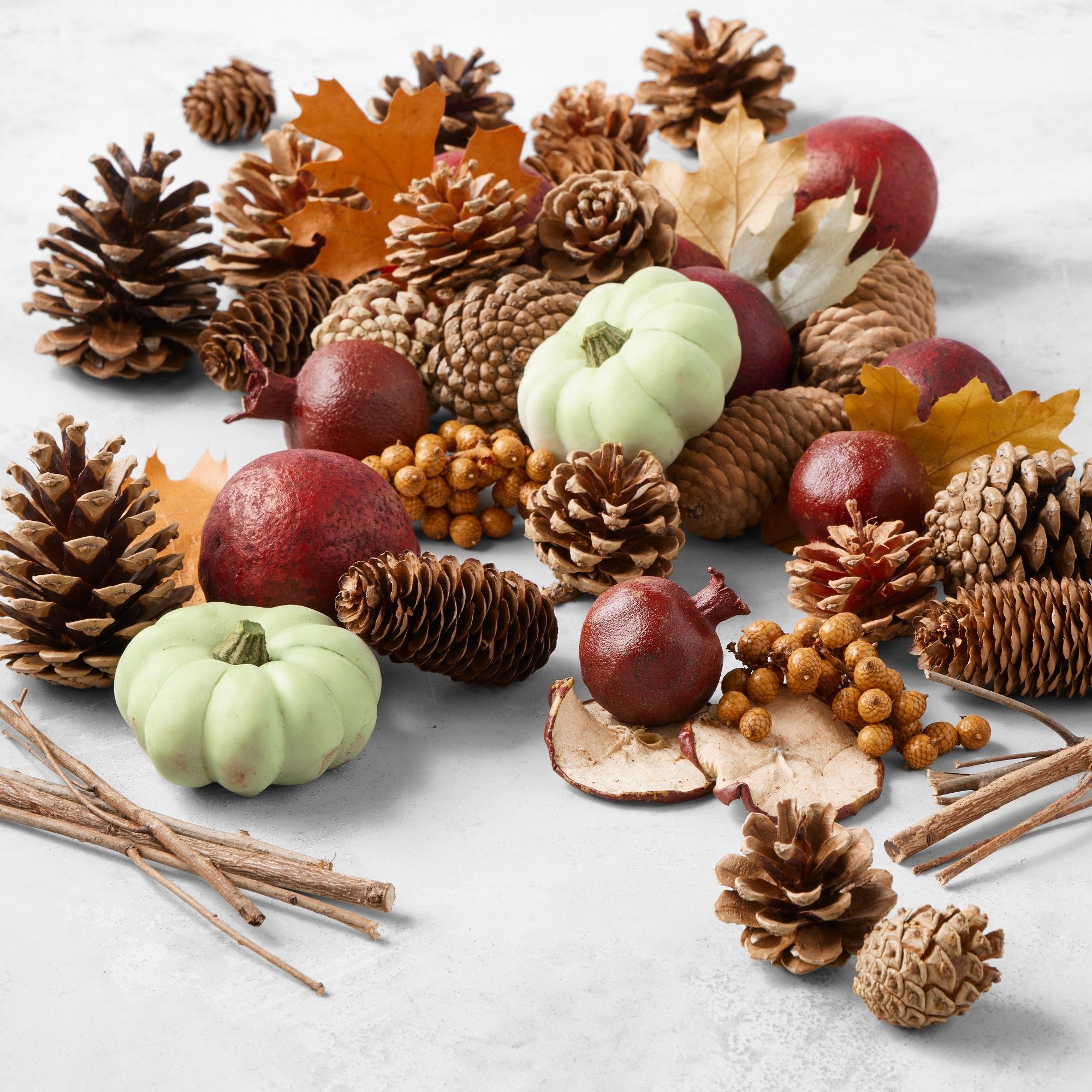Assortment of pinecones, faux berries, and faux pomegranates
