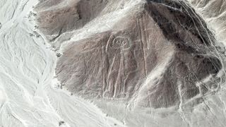Aerial photo of Nazca lines in Peru. This geoglyph look like a line drawing of an astronaut (humanoid).