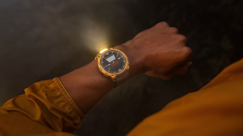 A photo of the Garmin Instinct Crossover AMOLED watch with the flashlight active on a person&#039;s wrist at night