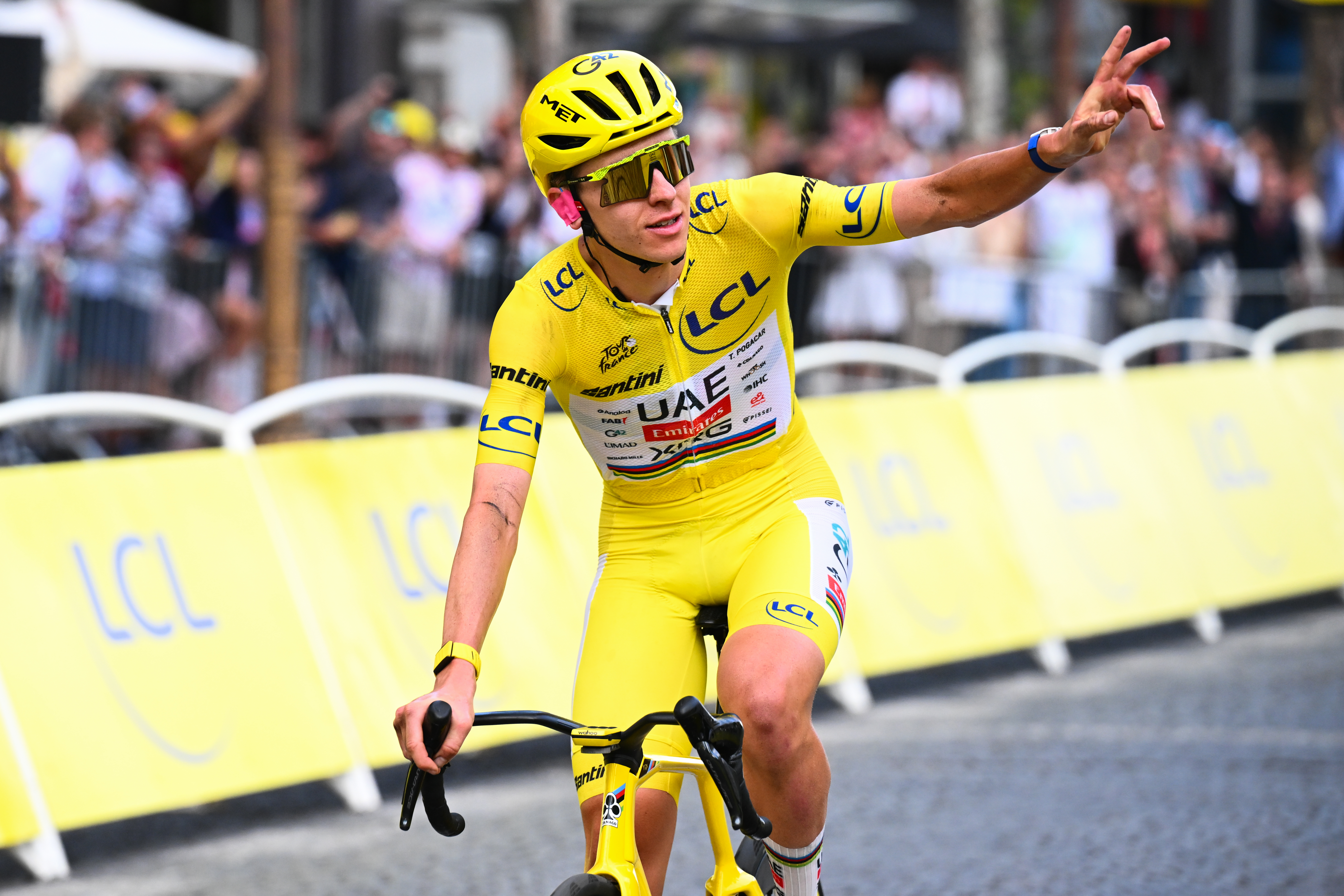 Tadej Pogačar riding on the final stage of the 2026 Tour de France in Paris in a yellow skinsuit
