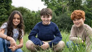 Dominic McLaughlin, Arabella Stanton, and Alastair Stout in a field, smiling
