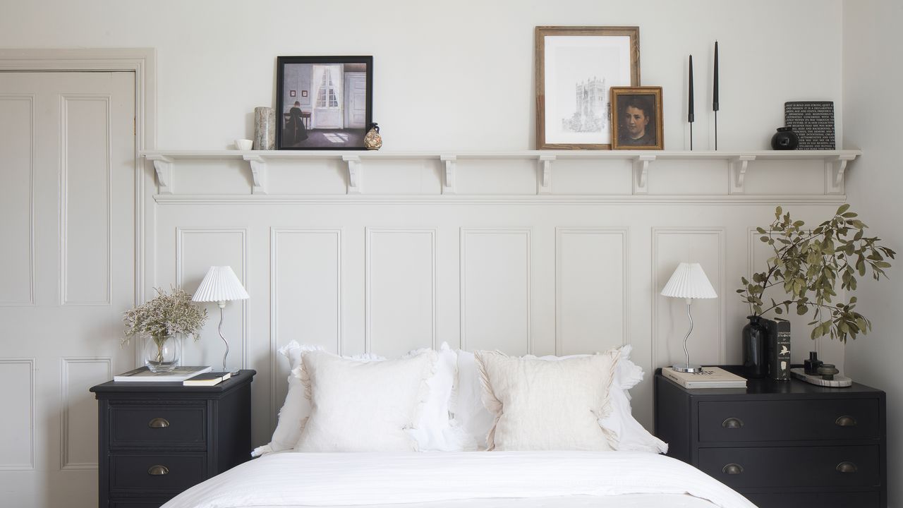 White bedroom with wall panelling and open shelving