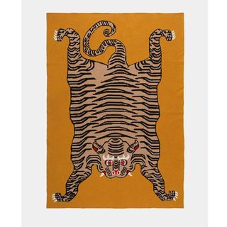 Yellow throw with large tiger motif.