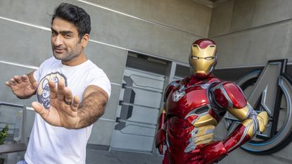 Kumail Nanjiani posing with Marvel's Iron Man