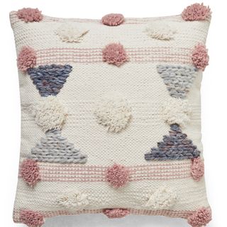 white cushion with pink pom pom