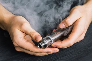 A person holding a vaping device.