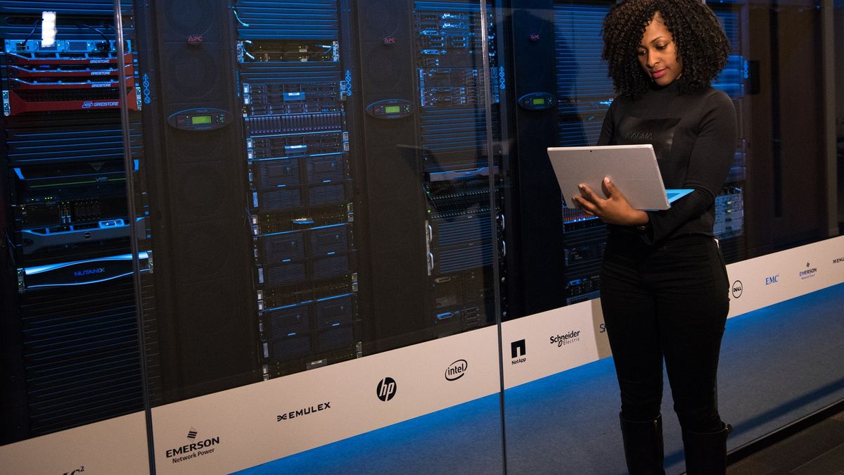 woman on laptop outside data centre