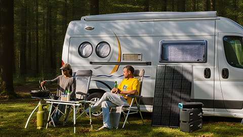 2 people outside of van with renogy products