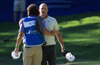 Noren hugs his caddy on the 18th hole