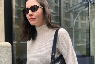 best bras, a close up photo of an editor wearing a white turtleneck top with a no-show bra