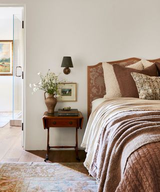 bedroom with dark wood table and brown fabrics