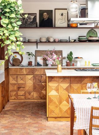 kitchen with terracotta tiles and wooden cabinetry