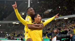 Borussia Dortmund's Jude Bellingham celebrates with teammate Youssoufa Moukoko after scoring his team's second goal in the DFP-Pokal match between Hannover 96 and Borussia Dortmund on 19 October, 2022 at the Heinz von Heiden Arena in Hannover, Germany