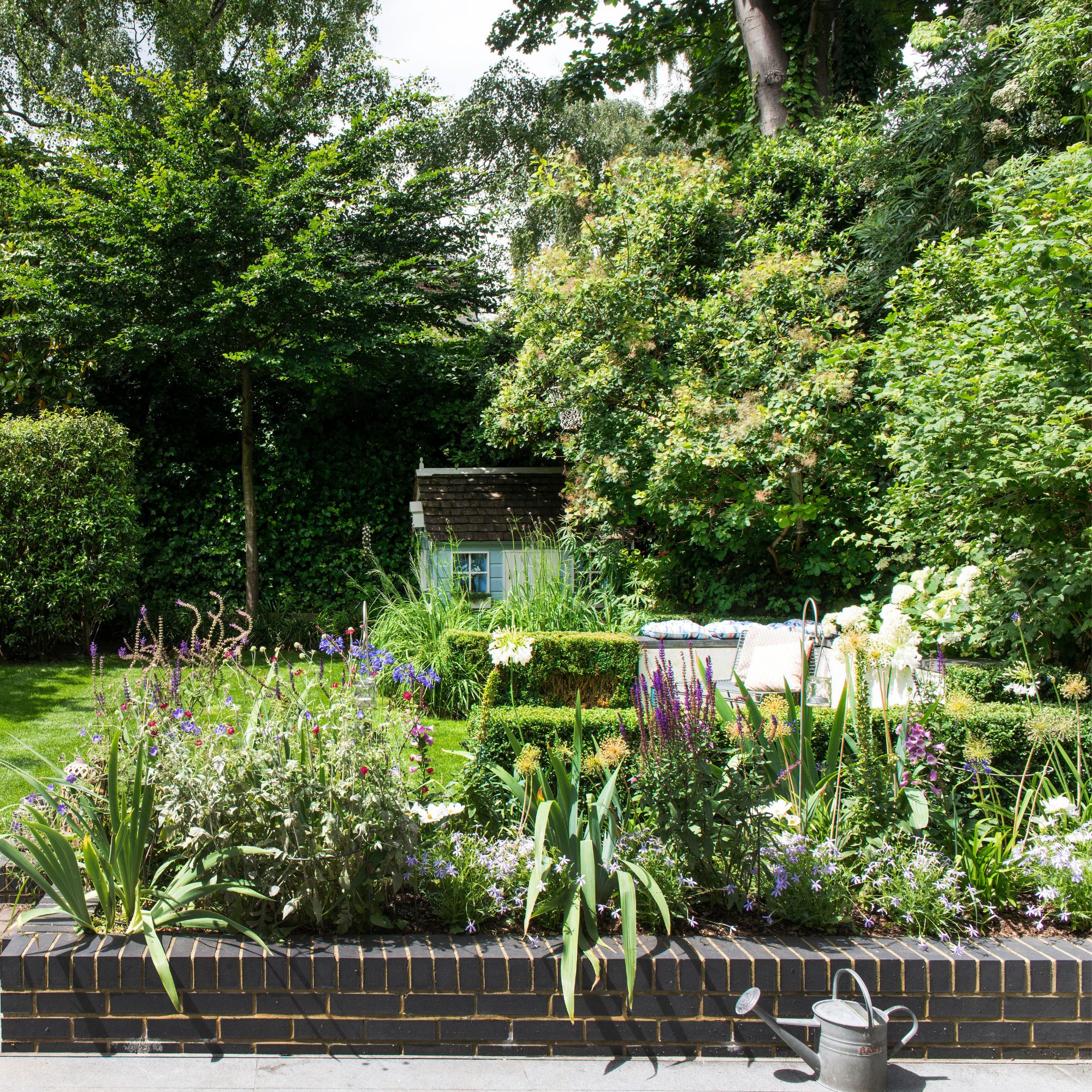 Flower bed border between patio and lawn