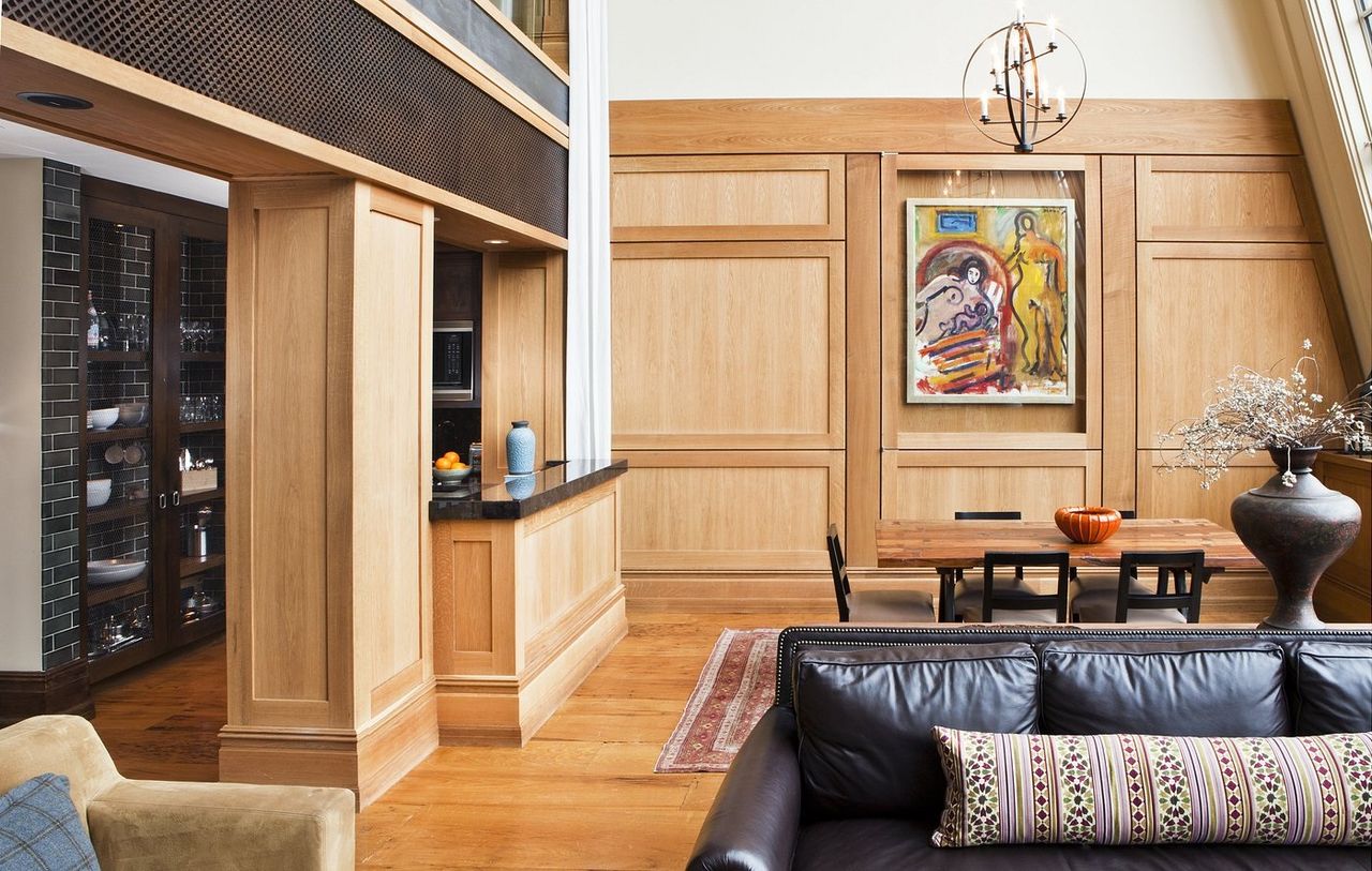 A modernism-inspired hotel features huge spaces letting plenty of natural light in, wooden and leather furnishings, wall art, and an earthy palette throughout its building.