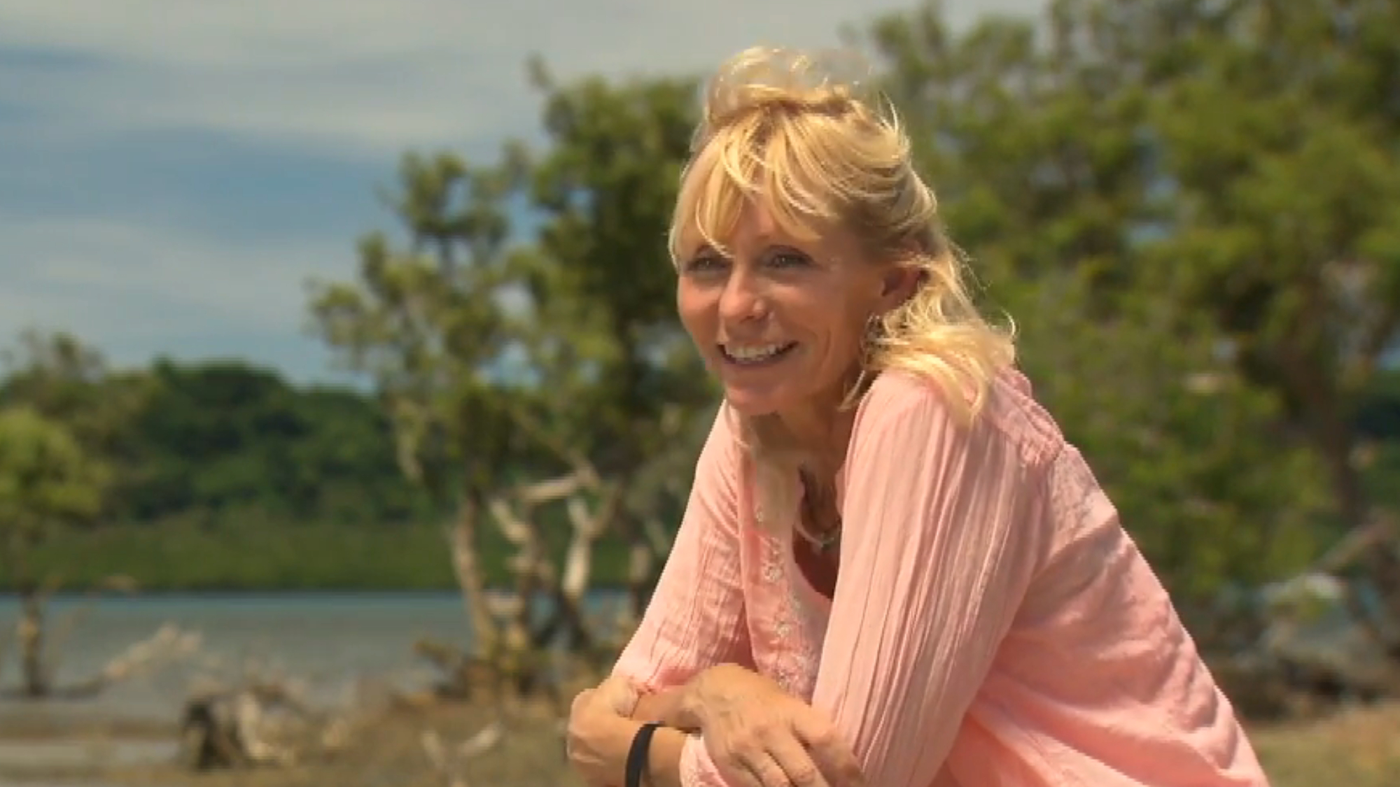 Tina talks during a confessional on Survivor Blood vs Water while wearing a pink shirt.