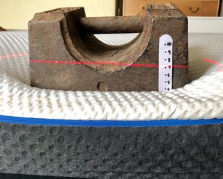 weight on the side of a mattress to show edge support