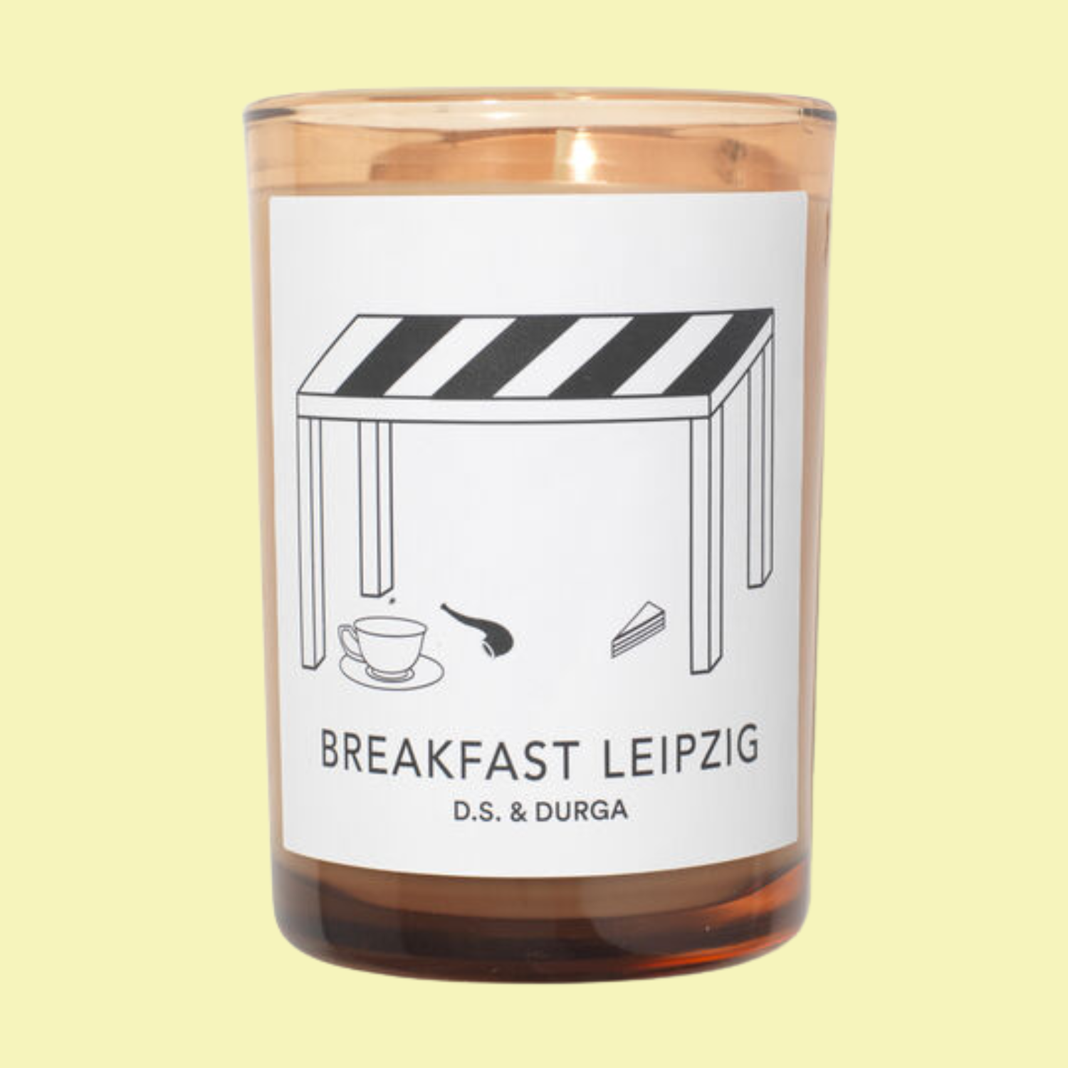 A scented candle in an amber glass