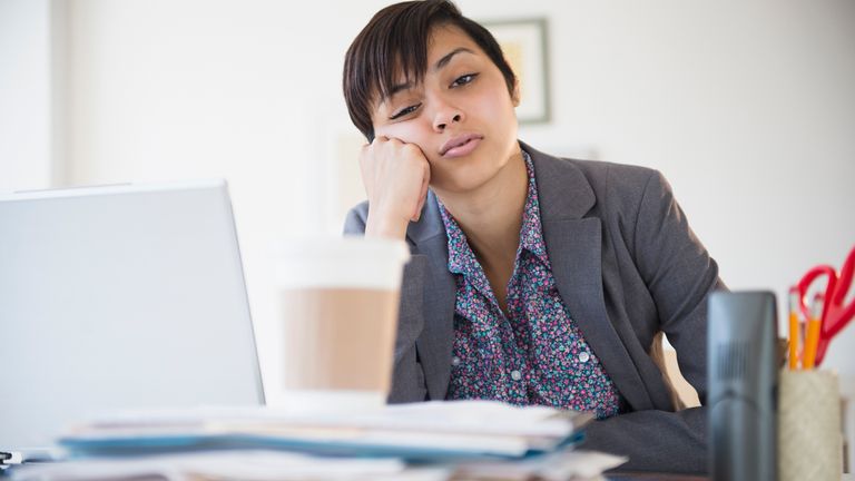 Woman suffering from long COVID at her work desk