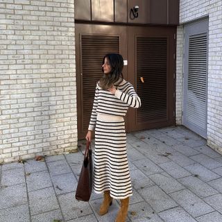 Autumn Boot Trends 2024: Influencer wears a striped knitted co-ord with tan suede boots