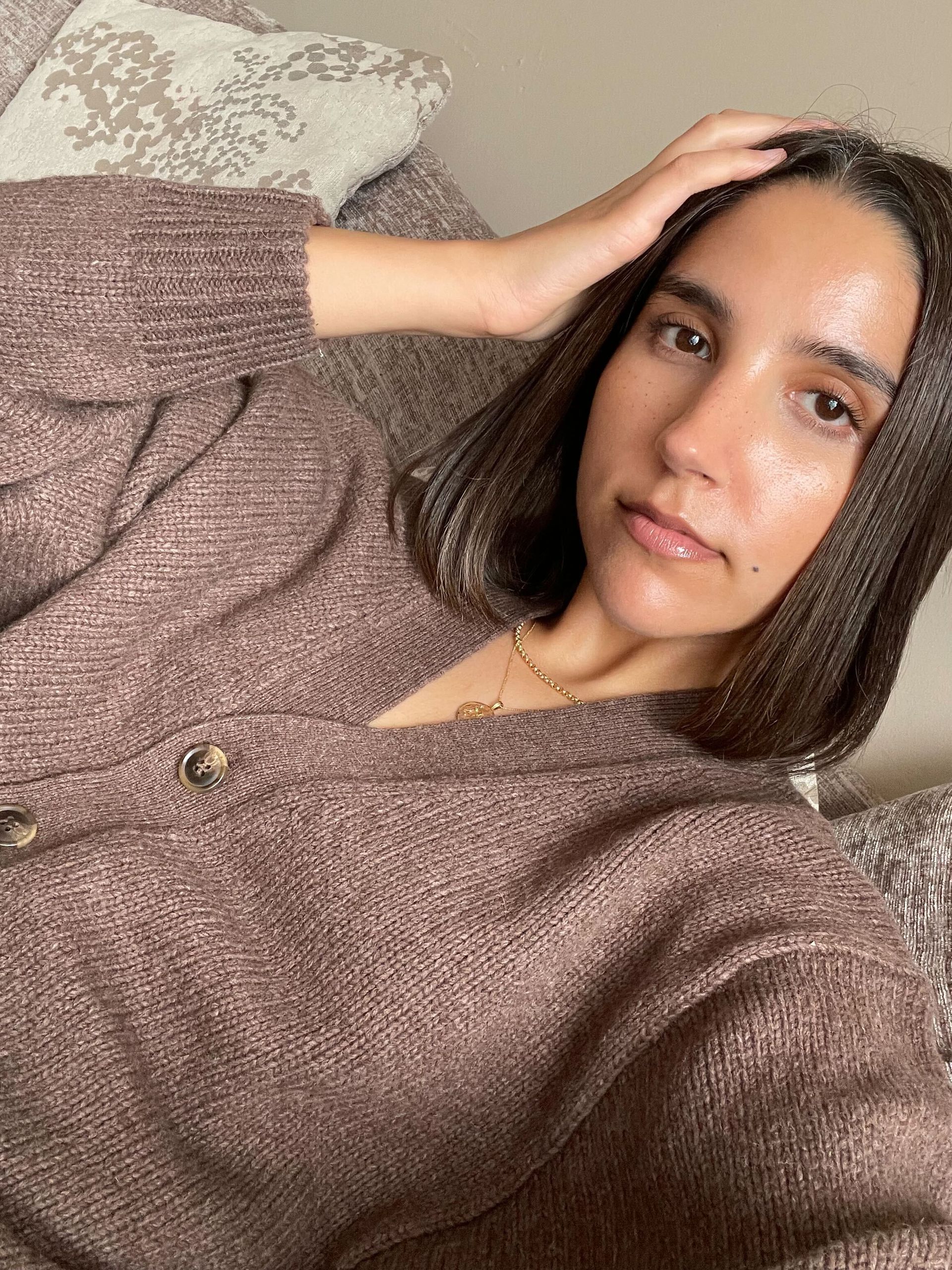 Humaa wears a soft brown cardigan