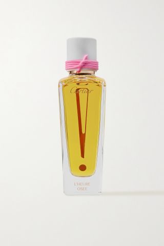 Cartier L’Heure Osée perfume in glass bottle with pink ribbon on cap