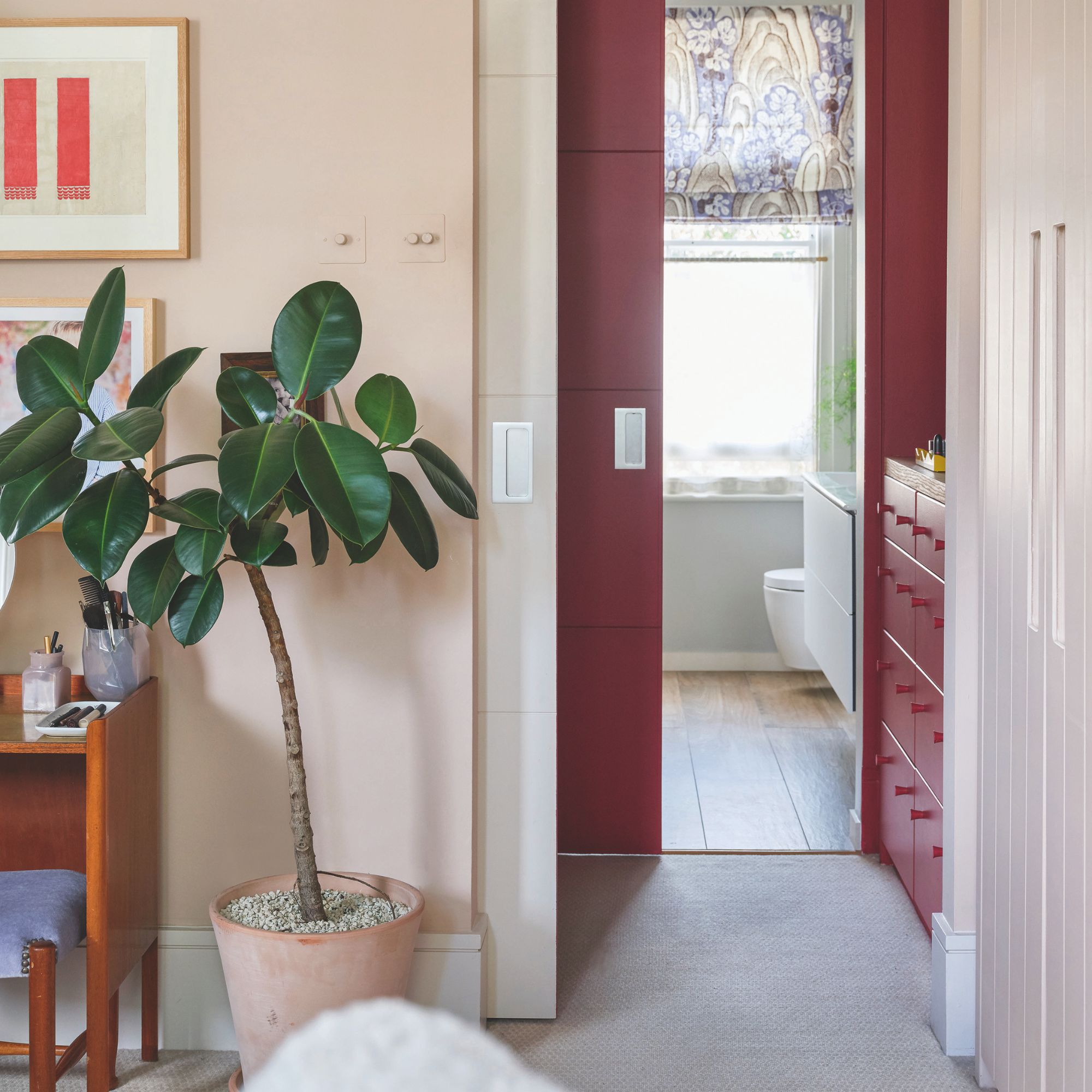 landing area with sliding doors to a bathroom, and a large potted plant next to the door