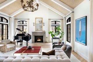 A living room with a vaulted ceiling and neutral color palette