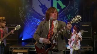 Jack Black playing guitar with The School of Rock band