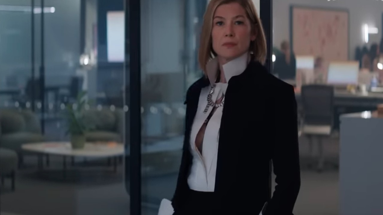Rosamund Pike standing in a suit in Ladies First.