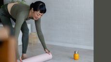 Woman rolling out yoga mat for the Copenhagen plank exercise