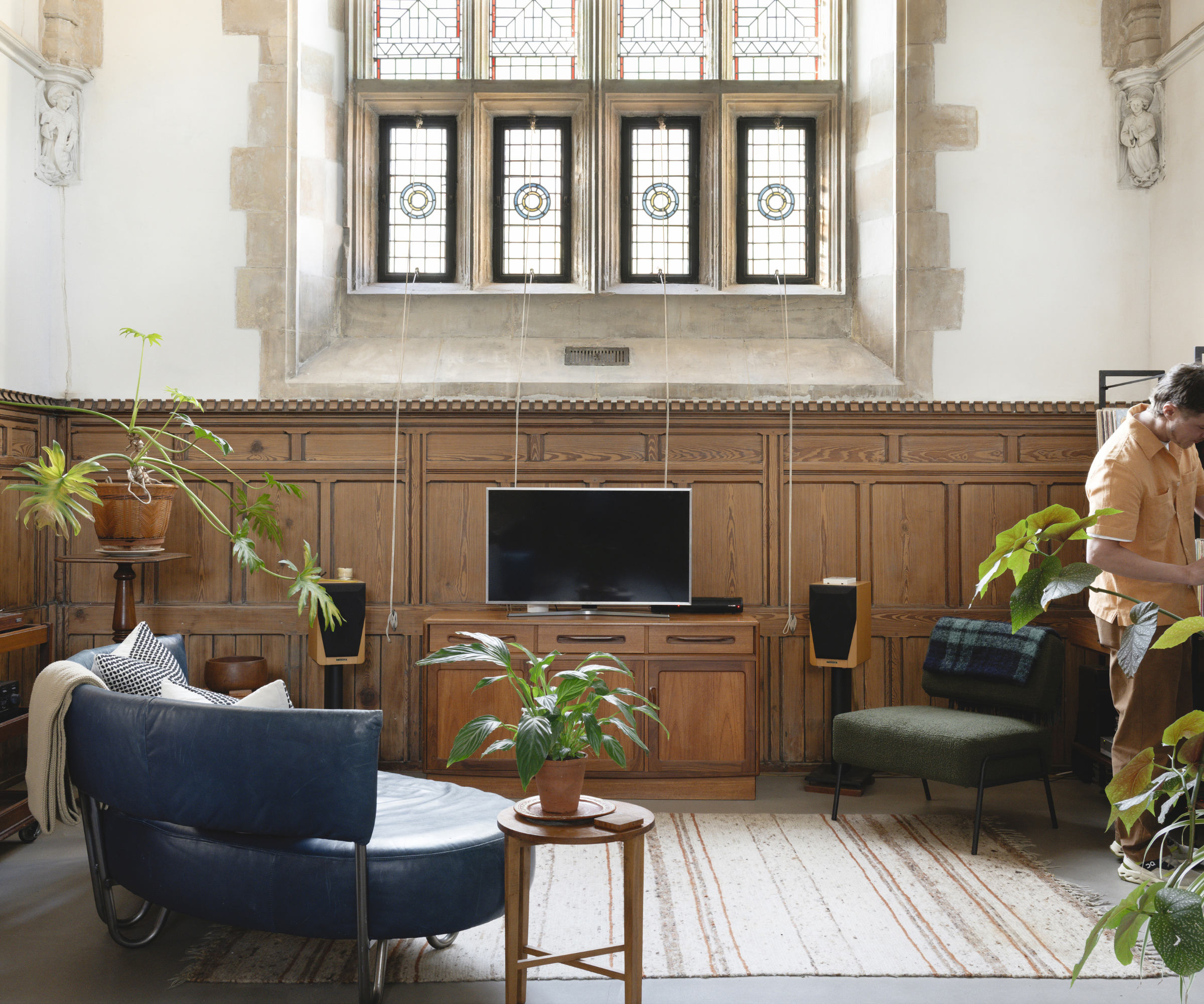 Living room area with wood paneling and stained glass window