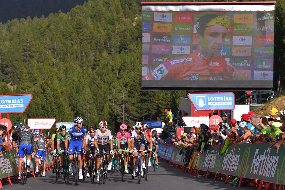 Simon Yates is interviewed on the big screen while the groupetto finishes stage 19 at the Vuelta