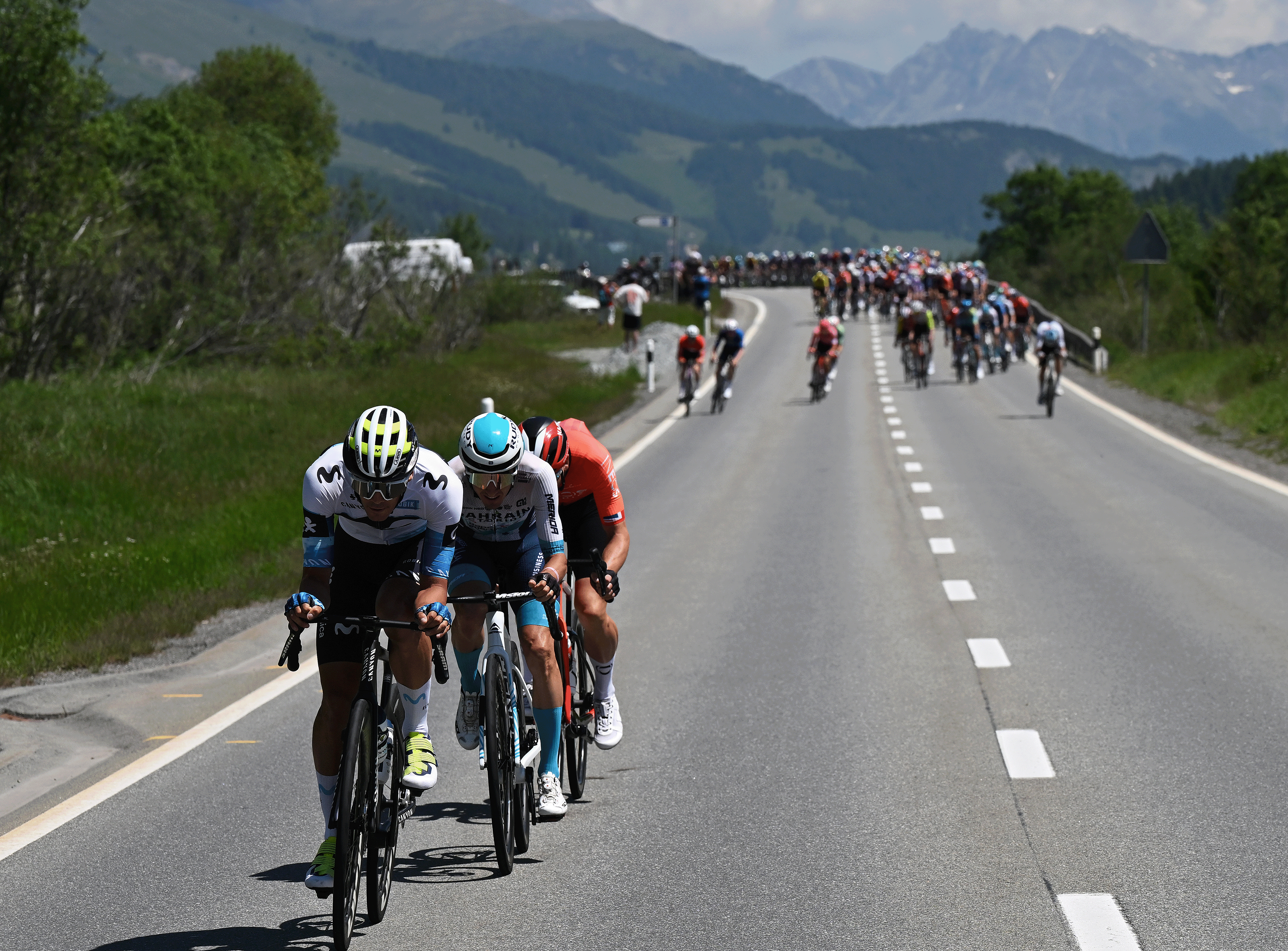 SANTA MARIA IN CALANCA, SWITZERLAND - JUNE 19: (L-R) Javier Romo of Spain and Team Movistar, Pello Bilbao of Spain and Team Bahrain - Victorious and Ben Swift of Great Britain and Team INEOS Grenadiers compete in the breakaway during the 88th Tour de Suisse, Stage 5 a 183.8km stage from La Punt to Santa Maria in Calanca 941m / #UCIWT / on June 19, 2025 in Santa Maria in Calanca, Switzerland. (Photo by Tim de Waele/Getty Images)