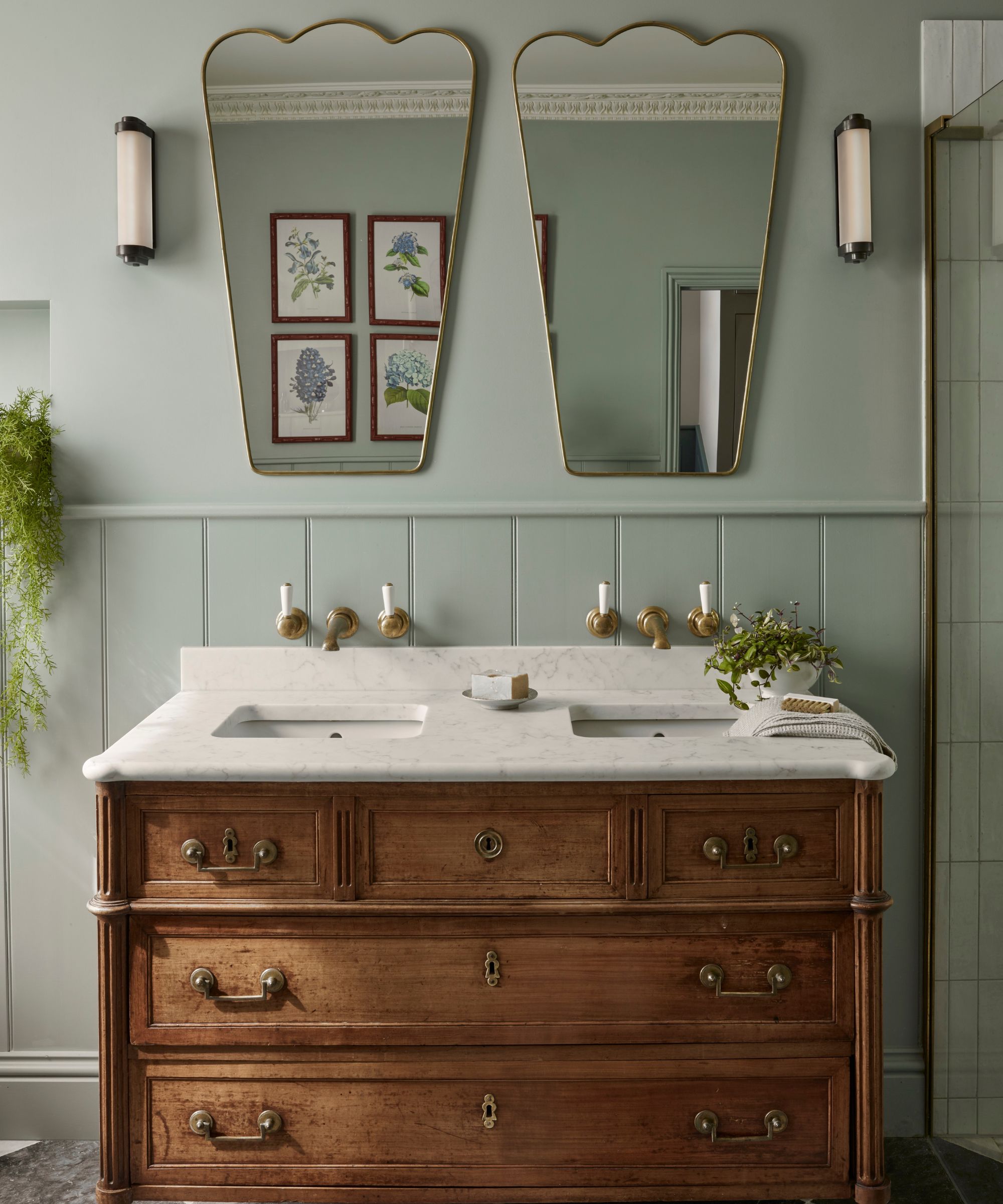 old meets new bathroom with antique double vanity and modern mirrors with panelled walls