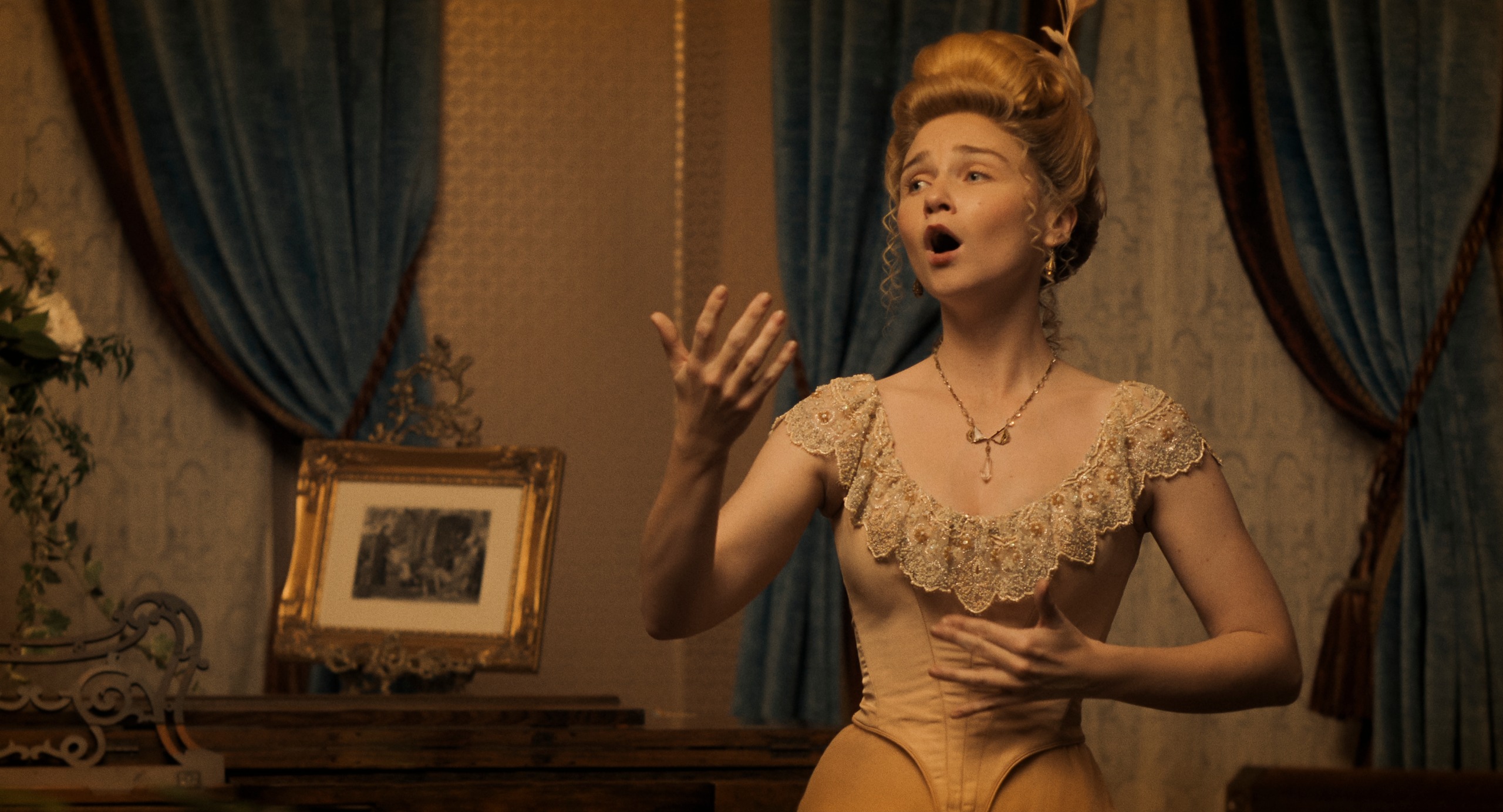 jessica barden as actress nance o'neil wearing 1800s era clothing and a wig singing in a home in a still from monster the lizzie borden story