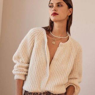 tried and tested gifts: woman wearing oversized cream cardigan unbuttoned at the top