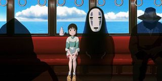 Chihiro and No-Face sitting on the train in Spirited Away